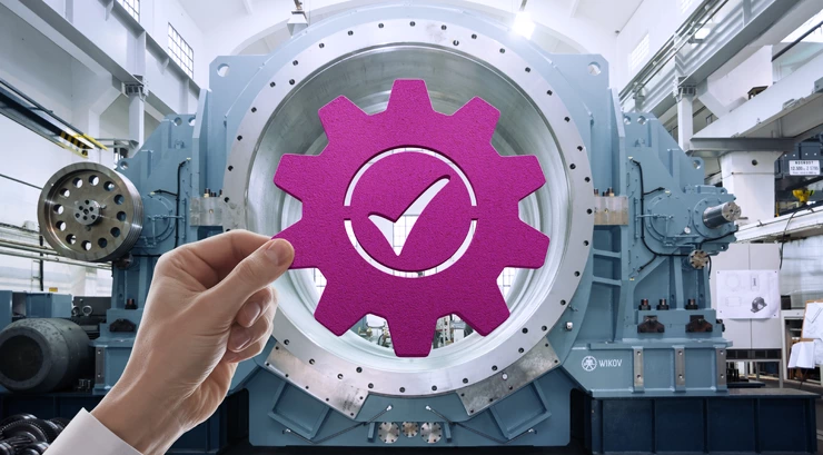 Symbol of a gear with check mark held up to industrial equipment
