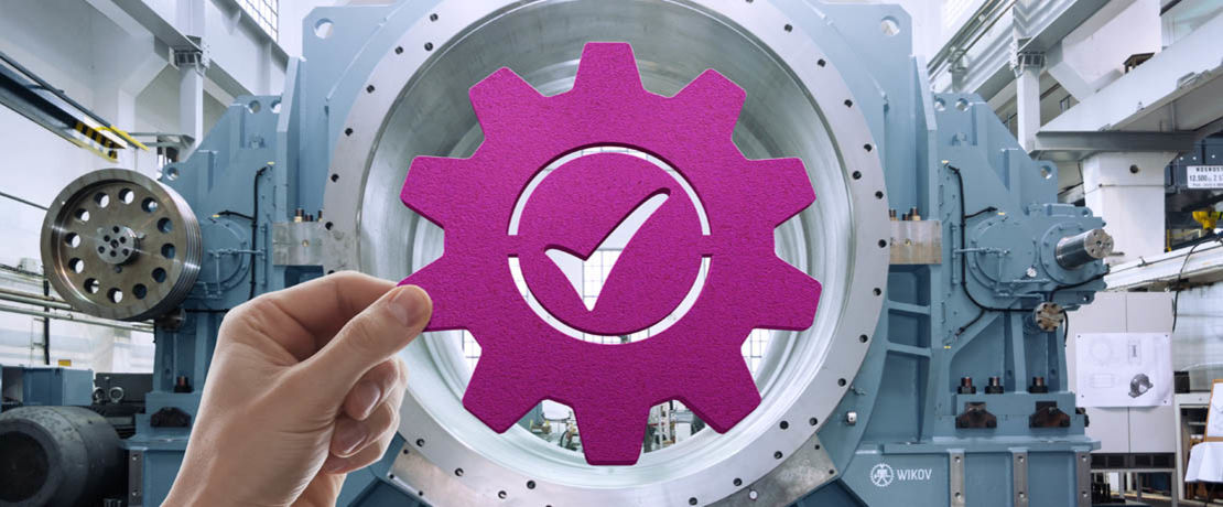 Symbol of a gear with check mark held up to industrial equipment